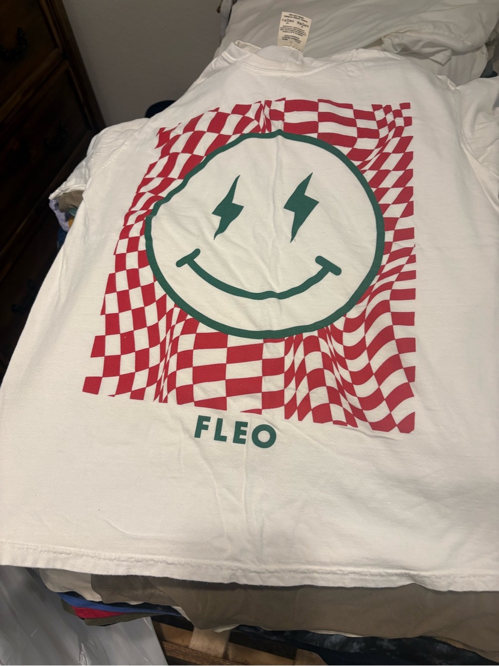 Fleo White Tee with Red Checkerboard and Green Smiley Logo
